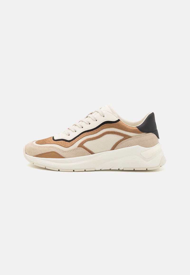 Beige och bruna sneakers med mocka och mesh-material, en böjd design, vadderad krage och kontrasterande svarta detaljer på hälen.