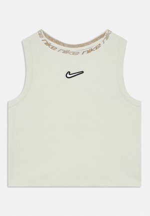 Gaiši bēša bezpiedurkņu īsais tops no mīksta kokvilnas ar melnu Nike logotipu krūtīs un rakstainu bēša krāsas apkakli.