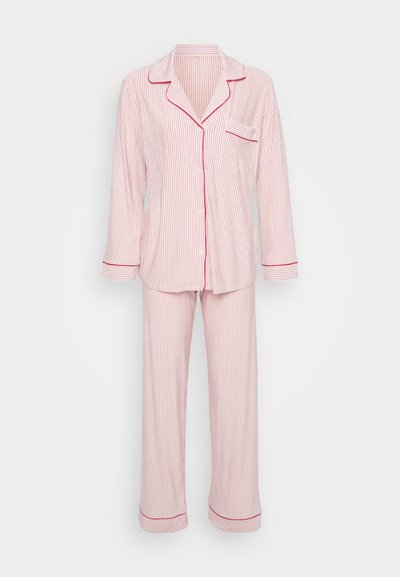 Conjunto de pijama às riscas vermelhas e brancas feito de tecido suave, com uma blusa com botões e um bolso, e calças longas com acabamento contrastante.