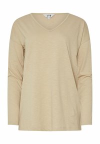Beige langärmliges V-Ausschnitt-Oberteil aus weichem, strukturiertem Stoff mit lockerer Passform und überschnittenen Schultern. Etikett am Ausschnitt sichtbar.