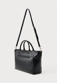 Black leather handbag with two top handles and a detachable shoulder strap. Features a front pocket and smooth, matte texture.