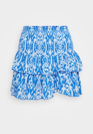 Sinine ja valge kihiline volangseelik, millel on ripsitud vöökoht ja abstraktne muster kerge kangas.