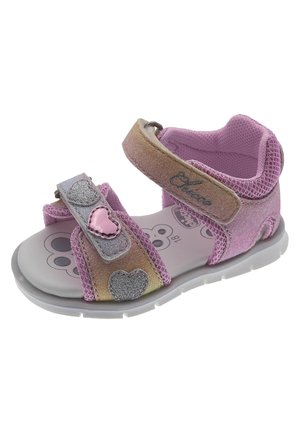 Sandalino per bambini di colore rosa con dettagli glitterati, cinturini regolabili, decorazioni a forma di cuore e suola in gomma grigia. Superiori testurizzati per il comfort.