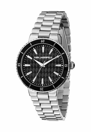 Sølvfarvet metalklokke med sort mønstret urskive, sølvfarvede timemarkører og en roterende sort ramme. Har en rem med led-links.