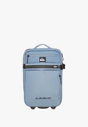 Light blue backpack with a padded design, featuring multiple zippered compartments, a top handle, and a black accent stripe across the front.