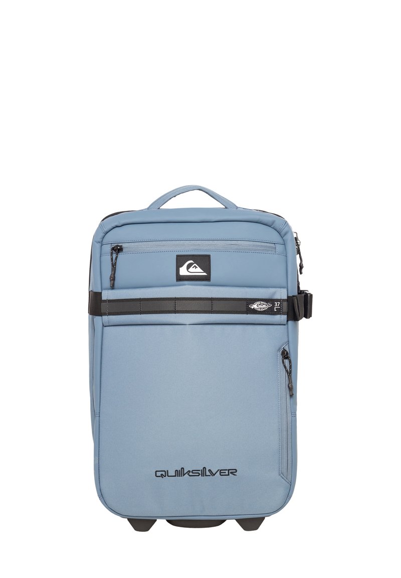 Light blue backpack with a padded design, featuring multiple zippered compartments, a top handle, and a black accent stripe across the front.