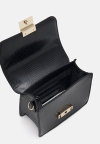 Black structured handbag with a textured finish, gold hardware clasp, and interior compartments. Features a ring on the side for a strap.