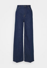 Jean en denim bleu foncé taille haute à coupe large, avec poches avant, passants de ceinture, fermeture par boutons et détails visibles de coutures.