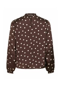 Blouse marron à manches longues avec des pois blancs, poignets et col froncés, et une petite ouverture en forme de trou de serrure à l'arrière du col.
