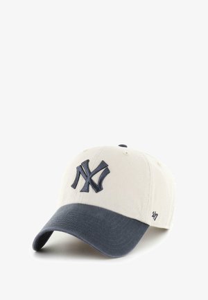 Baseball cap in light beige cotton with a dark navy curved visor. Features an embroidered NY logo in navy on the front.