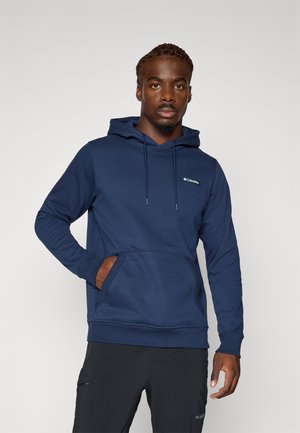 Hoodie bleu marine en tissu doux, doté d'une poche kangourou à l'avant, d'une capuche avec cordon de serrage et d'un petit logo sur la poitrine.
