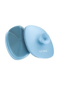 Blauer Silikon-Kopfhautmassagegerät mit weichen, erhöhten Borsten. Zirkulares Design mit einer strukturierten Oberfläche und einem zentralen Griffknopf. "GESKE" aufgedruckt.