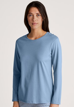 Camisetta a maniche lunghe azzurro chiaro con scollatura rotonda, realizzata in un tessuto morbido, caratterizzata da una texture liscia e una vestibilità comoda. Nessun motivo o dettaglio.