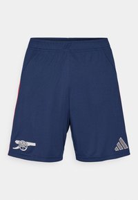 Marineblauwe shorts met rode accenten, voorzien van een logo op het linkerpijpje en een grijs Adidas-embleem rechts onderaan, gemaakt van lichtgewicht materiaal.