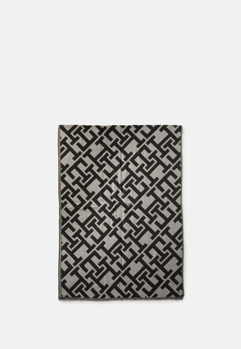 Sort og grå mønstrede tæpper med et geometrisk design. Blød tekstur med frynser i kanterne og rektangulær form. Måler ca. standard størrelse.