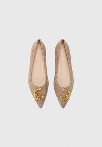 Ballerine beige in suede con punta affilata, caratterizzate da un'imponente rifinitura in oro nella forma di cerchi intrecciati.