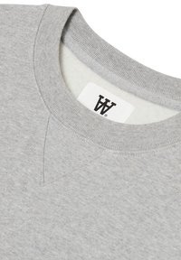 Light gray sweatshirt with a crew neck, textured fabric, and a logo label stitched inside the collar. Features a subtle v-stitch detail.