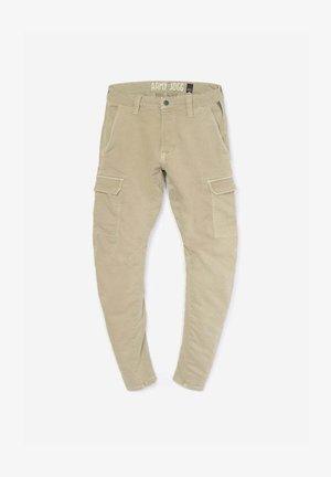 Pantalons de jogging beige avec une coupe fuselée, dotés de poches cargo latérales, d'accents cousus et d'un matériau en coton doux et texturé.