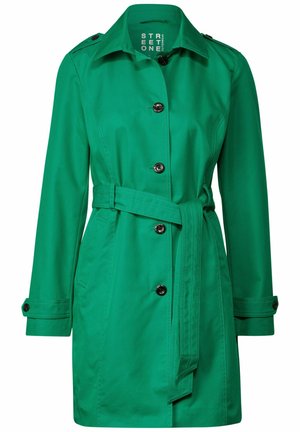 Grøn vandtæt trench coat med korte ærmer, sidelommer, en belagt talje og sorte knapdetaljer. Glat stoffinish.