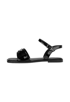 Zwarte gepatineerde leren sandalen met een platte zool, open teenontwerp en verstelbare enkelriem. Heeft een decoratief element op de bovenkant.