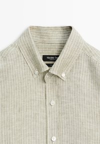 Light beige and white striped button-up shirt with a button-down collar and white buttons, laid flat on a white background.