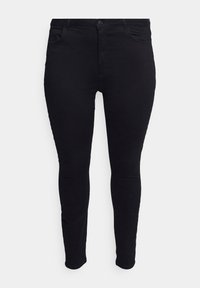 Vaqueros skinny negros y elásticos con una textura suave. Incluye un cierre de botón, trabillas para cinturón y cuatro bolsillos. Se ajusta ceñidamente a través de la pierna.