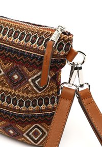 Borsa in tessuto intrecciato con schemi geometrici nei colori marrone, rosso e blu. Caratterizzata da una zip superiore e manici in pelle marrone per il trasporto. Accenti in hardware argentato.