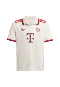 Polo de style blanc avec des accents rouges et rouge foncé, arborant un grand logo marron, un badge d'équipe et trois bandes rouges sur les épaules.