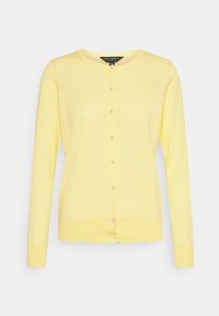 Gul kofta i mjukt material, med rund halsringning, lång ärm och pärlliknande knappar fram.