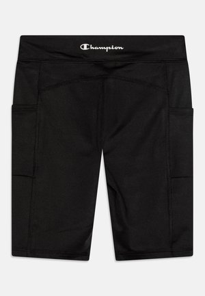 Shorts de sport noirs avec taille élastique. Comprend deux poches latérales et des coutures contrastées. Le matériau semble doux et extensible.