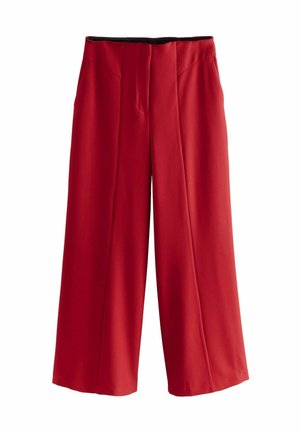 Pantalons larges rouges en tissu lisse, dotés de plis à l'avant, d'une taille plate et sans matériel visible.