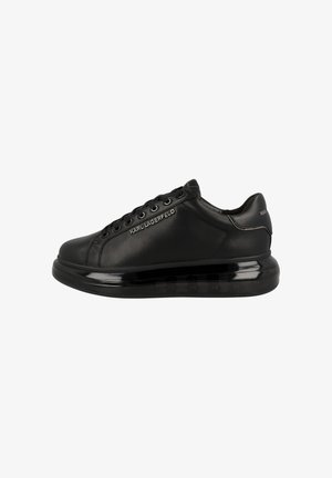 Black low-top sneaker with thick sole, lace-up front, and "KARL LAGERFELD" branding on the side and heel collar.