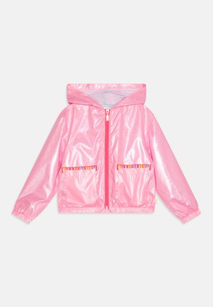 Bright pink, glossy rain jacket with a hood, front zipper, and elastic cuffs. Features two front pockets with a logo accent.