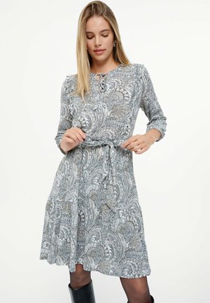 Langärmliges Kleid in Grau mit Paisleymuster, mit einer Schleife in der Taille und einem ausgestellten Rock, aus leichtem Material gefertigt.