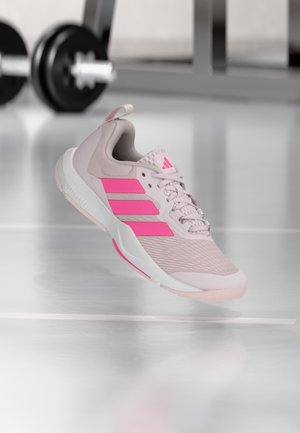 Light pink athletic shoe with pink accents and textured mesh upper. Features three stripes logo, padded collar, and white sole.