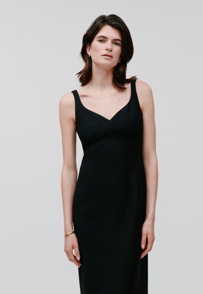 Black sleeveless dress with a V-neckline, fitted bodice, and a straight silhouette. Smooth fabric with minimal seams and no visible embellishments.