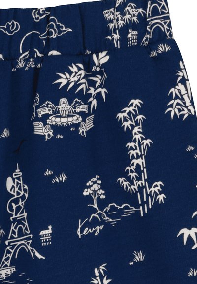 Blue fabric shorts featuring a white decorative pattern with elements like bamboo, a fountain, and a tower design. Elastic waistband at the top.