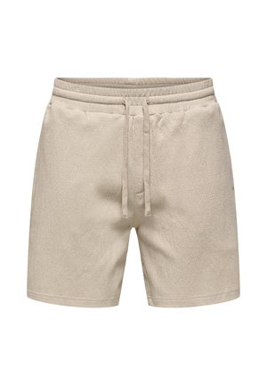 Short beige en éponge de coton avec taille élastique et cordon ajustable, poches avant, longueur mi-cuisse.