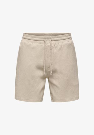 Short beige en éponge de coton avec taille élastique et cordon ajustable, poches avant, longueur mi-cuisse.