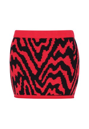 Trikotažinės trumpos sienos sijonas su raštų zigzagu raudonoje ir juodoje spalvose. Juostos dalis yra vienspalvė raudona, su tekstūruotu paviršiumi.