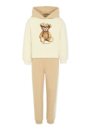 Beige katoenen hoodie en broek set. De hoodie heeft een teddybeer graphic met zonnebril en sprankels. Zacht materiaal met geribbelde boorden.