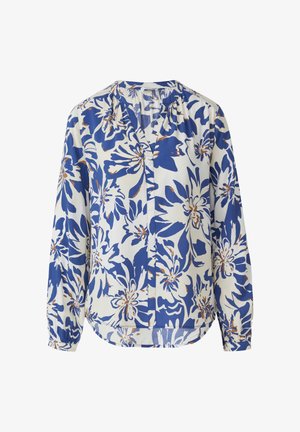 Bluzica dugih rukava od bijelog materijala s boldnim plavim cvjetnim uzorkom i smeškastim detaljima. V-izrez i opušteni kroj.