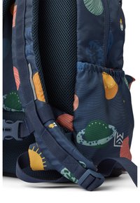 Mochila de tejido azul oscuro con patrones de planetas coloridos. Cuenta con detalles de malla, correas ajustables y un bolsillo lateral con elasticidad.