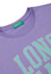 Purple cotton t-shirt with a round neckline, featuring bold green text and pink glitter accents. Tag reads "United Colors of Benetton."