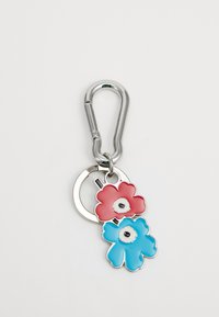 Metal keychain featuring a silver carabiner, attached to two enamel flowers: a red flower on top with a white center and a blue flower beneath.