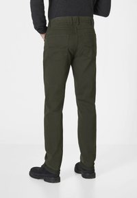 Olive green cotton pants with a straight cut, featuring two back pockets and subtle stitching details. Paired with black shoes.