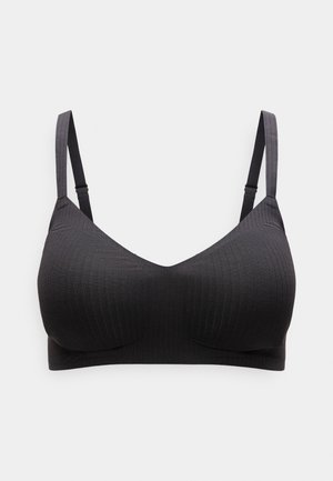 Sort ribbet bralette med justerbare stropper, blød tekstur og v-halsdesign. Enkel og sømløs konstruktion for komfort.