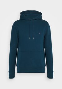 Sudadera con capucha en azul oscuro, con un bolsillo frontal, puños de canalé y un pequeño logo en el pecho. Tejido suave con una textura lisa.