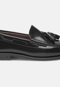Zwarte leren loafer met een gladde afwerking, voorzien van een decoratieve kwast, contrasterende stiksels en een lage rubberen zool.