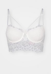 Čipkast bralet u bijeloj boji s podstavljenim kupovima. Ima cvjetni uzorak, podesive satenske trakice i detalj s otvorom sprijeda.